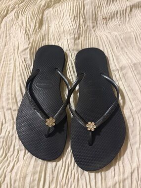 Havaianas Women's Black Flip Flops with Gold Flower Charm